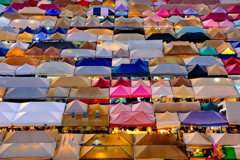 Colorful market tents at sunset. Fairs and marketplaces