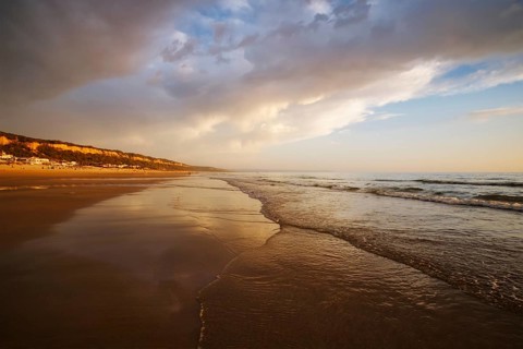 Atlantic ocean sunset with surging waves at Fonte da Telha beach