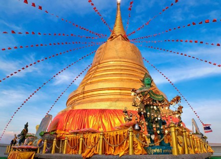 Statue of green-skinned Thai angel holding roll with message in Thai