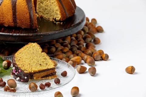 Vegan hazelnut cake on wooden serving plate