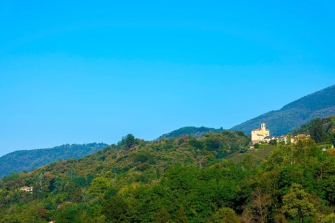 Church in Castelrotto and Village on Mountain Range and Valley with Sky in a Sunny Summer Day in Malcantone