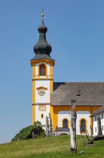 Wooden sculptures at the Stations of the Cross on Kirchberg with parish church