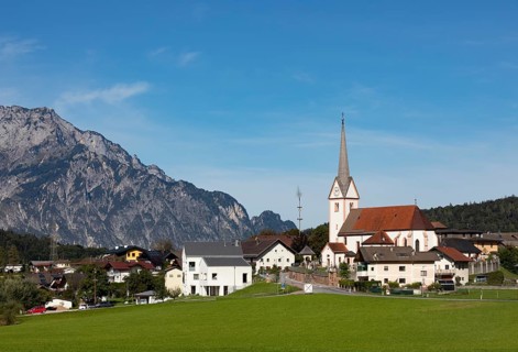 Village view with parish church of Adnet with Untersberg