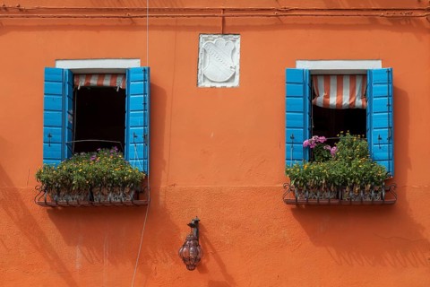 Orange house facade with two windows