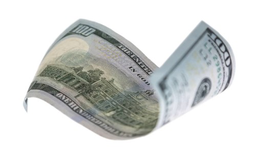 One hundred dollar bill falling or floating on empty background
