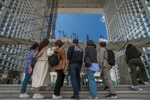 Tourists take a souvenir photo in the Grand Arche