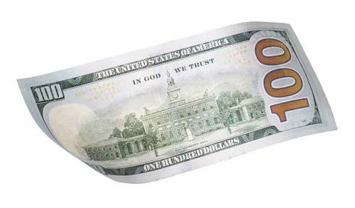 One hundred dollar bill falling or floating on empty background