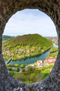 View of the Doubs River and the town of Besancon through a circular window in the World Heritage Site of Besancon Citadel