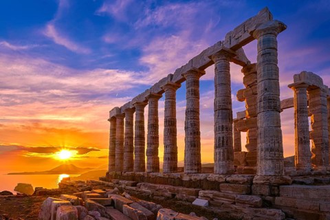 Beautiful sunset sky and ancient ruins of temple of Poseidon