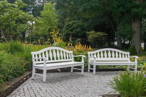 Two white park benches