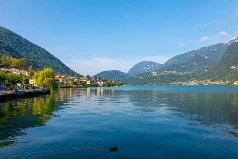 Waterfront in City of Riva San Vitale with Mountain View on Lake Lugano in a Sunny Summer Day in Riva San Vitale