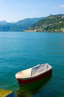 One Boat on the Waterfront in a Sunny Summer Day and on Lake Lugano and Mountain View over Morcote