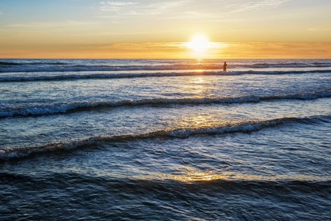 Atlantic ocean sunset with surging waves at Fonte da Telha beach