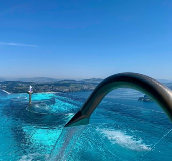 Infinity Swimming SPA Pool with View over Mountain and Lake Lucerne in a Sunny Day in Buergenstock
