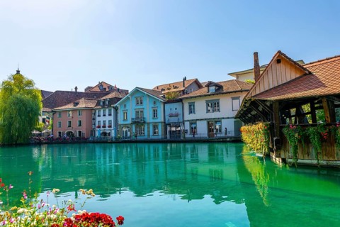 River Aare in City of Thun and Untere Schleuse Wooden Bridge in a Sunny Summer Day in Thun