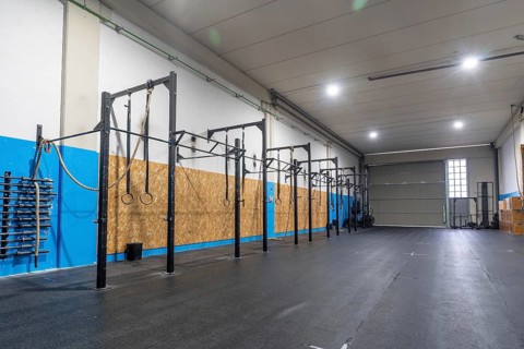 Empty space of a cross training room with bars and Olympic rings