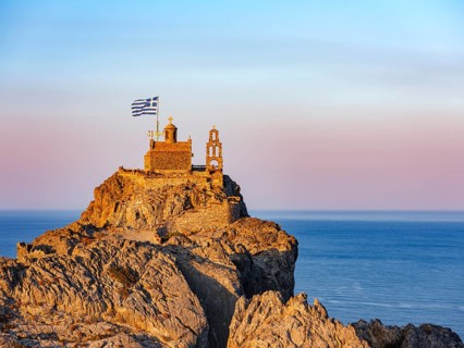 Chapel of St. Paisios perched on rocks at sunrise