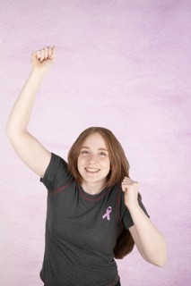 Woman wearing a pink breast cancer awareness ribbon. Concept of struggle with breast cancer