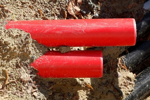 Red pipes in the sand on a construction site