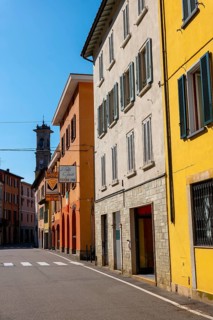 City Street in Porto Ceresio and Church Tower in a Sunny Summer Day in Porto Ceresio