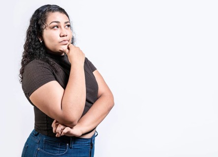 Thoughtful people with hand on chin. Latin girl wondering with hand on chin isolated