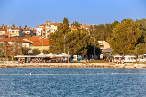 Beach on the stone coast of City Beach of Porec