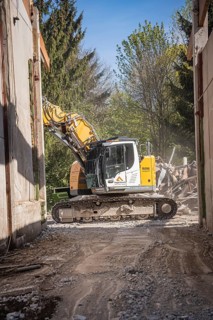 Yellow Liebherr crawler excavator recycling on demolition site