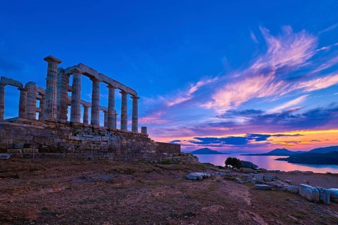 Beautiful sunset sky and ancient ruins of temple of Poseidon