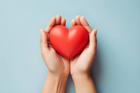 Top view showing woman's hands gently holding a fragile heart. AI generated