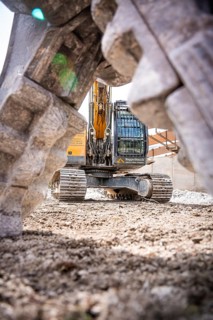 Yellow Liebherr crawler excavator recycling on demolition site