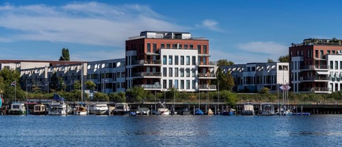 Illegally anchored houseboats in the Rummelsburg Bay with the residential houses on the Rummelsburg shore