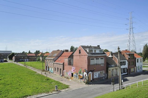 The desolate Flemish polder village Doel along the Antwerp port with abandoned houses covered in graffiti by squatters