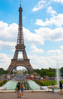 Young lovers in front of the Eiffel Tower