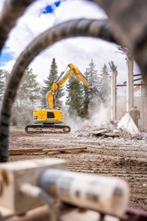 Yellow Liebherr crawler excavator recycling on demolition site