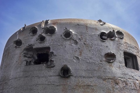 Battle-scarred World War Two 60 ton armoured bell of German coastal battery at D-Day Omaha Museum
