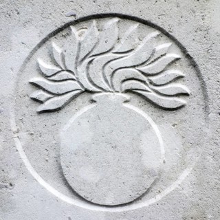 Grenadier guards regimental badge on headstone at Cemetery of the Commonwealth War Graves Commission for First World War One British soldiers
