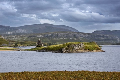 16th century Ardvreck Castle ruins at Loch Assynt in the Highlands at sunset