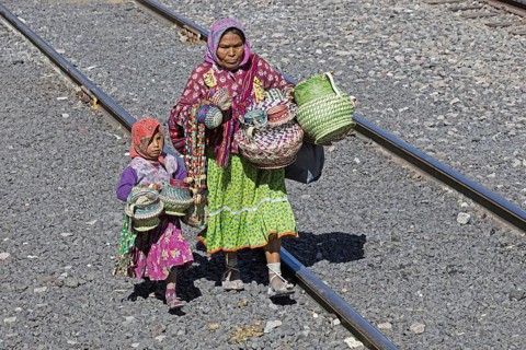 Mexican woman with child selling souvenirs to tourists on the tourist train of the Chepe Express