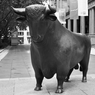Figure Bull in front of the Frankfurt Stock Exchange