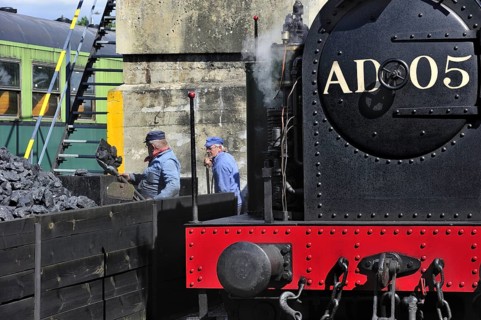 Men loading coal as fuel for steam train at the depot of the Chemin de Fer a Vapeur des Trois Vallees at Mariembourg