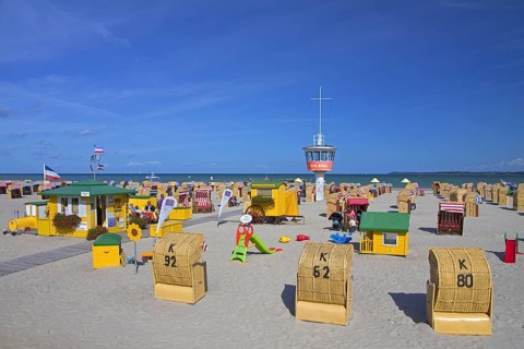 Roofed wicker beach chairs on the beach at Travemuende