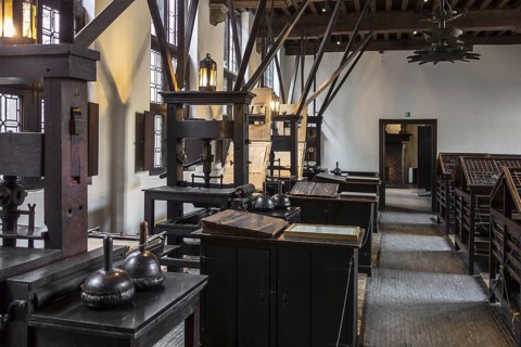 Print shop showing 18th century type cases and 17th century printing presses in the Plantin-Moretus Museum