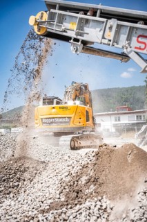 Yellow Liebherr crawler excavator recycling on demolition site