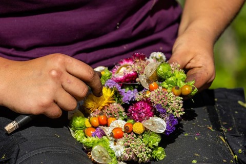 Florist weaving dried flower wreath