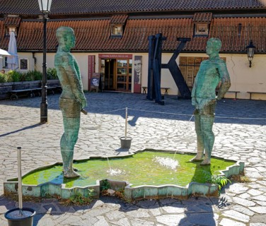 Two male figures peeing