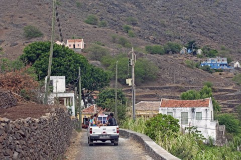 Tourists and locals transported in the back of pickup truck in rural countryside on the island Sao Nicolau