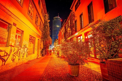 Restaurant and pub alleyway Wagnergasse in Jena at night with the Jentower in the background