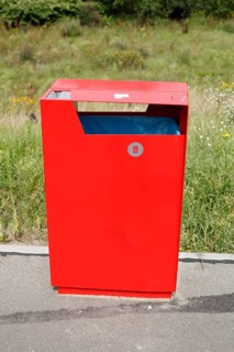Red metal public waste bin