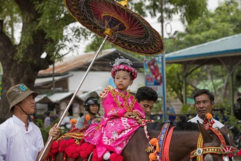 Traditional parade for Burmese child becoming a novice monk in the city Bagan
