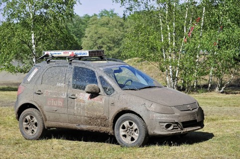 Suzuki SX4 four-wheel drive off-road vehicle covered in mud after rally racing